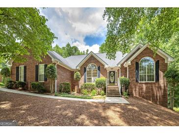 Charming brick home featuring a well-manicured lawn and inviting entrance perfect for a Gathering at 110 Chardonnay Oaks Dr, Mcdonough, GA 30252