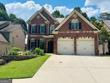 Beautiful two-story brick home with a two-car garage and well-manicured lawn at 705 Lawton Bridge Sw Rd, Smyrna, GA 30082
