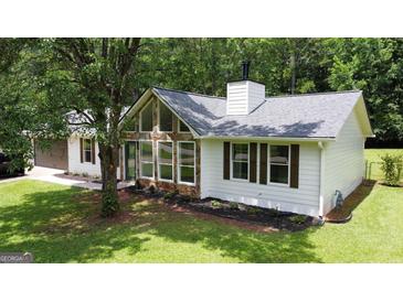 Charming home featuring stone accents, fresh landscaping, and a neatly maintained lawn at 125 Selena Ct, Fayetteville, GA 30215