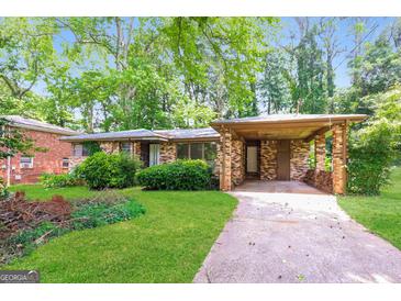 Charming single-story home with a brick facade, mature trees, and a covered carport at 2282 Belmont Dr, Decatur, GA 30032