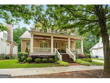 Charming brick home with a spacious front porch and manicured landscaping at 5130 Pratt Sw St, Covington, GA 30014