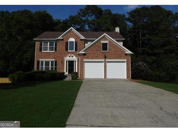 Beautiful two-story brick home with a two-car garage and a well-manicured lawn at 7505 Brookwood Way, Cumming, GA 30041