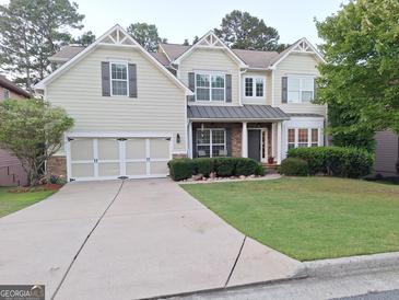 Charming two-story home with a well-manicured lawn, neutral siding, and a two-car garage at 522 Blue Mountain Rise, Canton, GA 30114