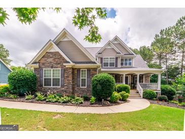 Charming two-story home with stone accents, manicured landscaping, and inviting front porch at 53 Denny Ln, Dallas, GA 30157