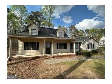 Charming home featuring a welcoming front porch, well-maintained lawn, and attractive curb appeal at 110 Riley Ave, Fayetteville, GA 30214