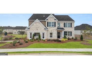 Charming two-story home with brick accents, landscaped yard, and welcoming front door at 687 Edgar St # 83, Hampton, GA 30228