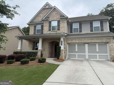 Charming two-story home featuring a brick and siding exterior, complemented by a well-manicured front yard at 2920 Prestwood Dr, Cumming, GA 30040
