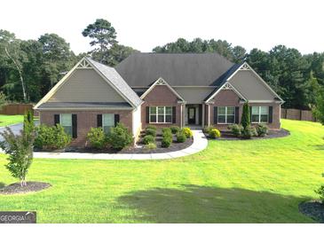 Charming brick home with well-manicured lawn and landscaping for great curb appeal at 116 Standford Dr, Mcdonough, GA 30252