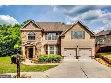 Charming two-story home with a manicured lawn, complemented by a two-car garage and classic brick accents at 697 Chapman, Jonesboro, GA 30238