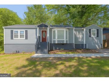 Charming single-story home featuring a red door, bay window, and gray siding at 1675 Brewer Sw Blvd, Atlanta, GA 30310