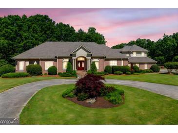 Stately brick home with manicured landscaping and a circular driveway at 226 Euharlee Five Forks Rd, Kingston, GA 30145