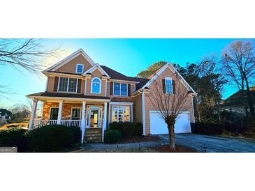 Charming two-story home featuring a blend of stone and siding, complemented by a well-manicured front yard at 190 Country Club Dr, Hiram, GA 30141