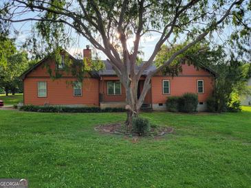 Charming home with a tree-filled yard and inviting front entrance at 45 Oak Wood Lane, Covington, GA 30016
