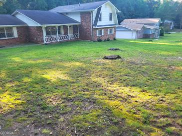 Charming two-story home with brick accents and large front yard at 3211 Rockview Dr, Lithonia, GA 30038