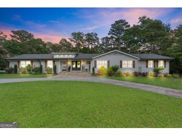 Charming single-story home with well-manicured lawn, stone walkway, and inviting front entrance at 396 Ebenezer Rd, Fayetteville, GA 30215