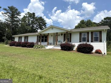 Charming single-story home featuring a well-manicured lawn and classic brick exterior at 4790 Hwy 101 N, Rockmart, GA 30153