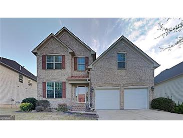 Charming two-story brick home with a two-car garage and manicured front lawn at 5598 Jamerson Dr, Atlanta, GA 30349