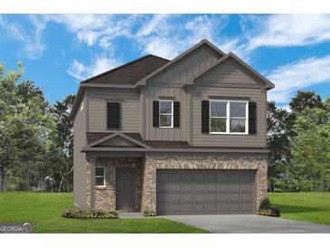 Charming two-story home featuring a brick front, gray siding, and attached two-car garage at 10422 Trellis Lane (Lot 38), Hampton, GA 30228