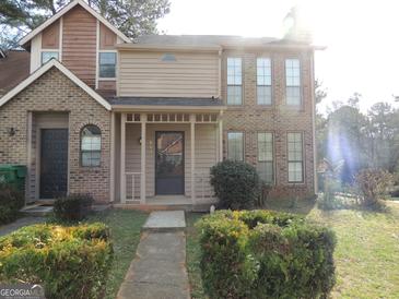 Charming townhome with a manicured front yard and inviting covered entryway at 883 Heritage Oaks Dr, Stone Mountain, GA 30088