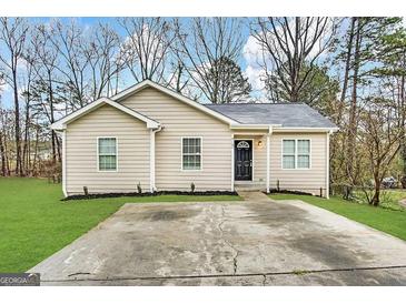 Charming single-story home with a well-maintained front yard and a concrete driveway at 9107 Morris Sw Dr, Covington, GA 30014