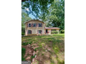 Charming two-story home with a well-maintained lawn and mature trees at 491 Allana Ct, Stone Mountain, GA 30087