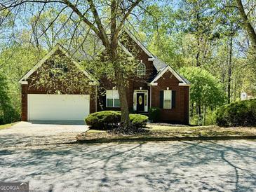 Charming brick home with a well-manicured lawn and inviting front entrance, perfect for a Gathering at 2481 Weatherstone Cir, Conyers, GA 30094