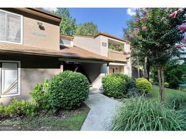 Inviting condo exterior with lush landscaping and private entrance, enhancing curb appeal at 843 Seasons Pkwy, Norcross, GA 30093