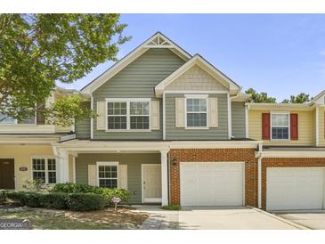 Charming townhome with a one-car garage, landscaped front yard, and a welcoming entrance at 2203 Hyssop Way, Buford, GA 30519