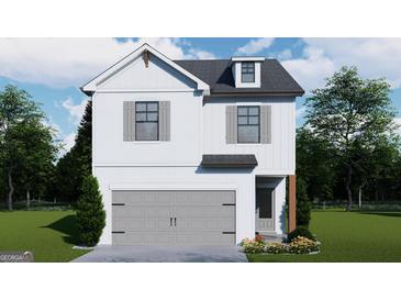Charming two-story home featuring a gray garage door, complemented by a landscaped front yard and neutral-toned shutters at 4464 Eastbrook Pl # 56B, Snellville, GA 30039