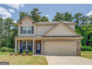 Charming two-story home featuring a brick facade, neutral siding, and a two-car garage at 116 Sophie Cir, Locust Grove, GA 30248
