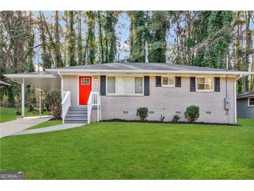 Charming brick home with a bright red door, well-manicured lawn, and inviting curb appeal at 2644 Connally Dr, East Point, GA 30344