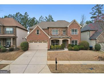 Beautiful two-story brick home with a manicured lawn and attached two-car garage at 2126 Roberts View Trl, Buford, GA 30519