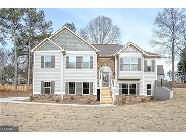 Charming two-story home featuring stone accents, shutters, and a welcoming front porch at 6005 Crowley Dr, Douglasville, GA 30135