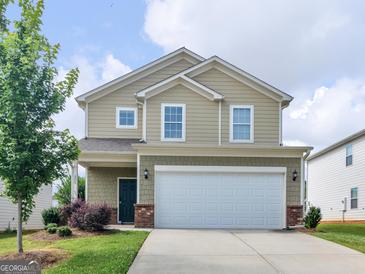 Charming two-story home with a two-car garage, manicured lawn and inviting curb appeal at 505 Mariposa Ln, Mcdonough, GA 30253