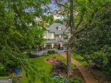 Charming two-story home with a sprawling porch and manicured lawn and garden at 53 Born St, Norcross, GA 30071