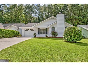 Charming single-story home with a well-maintained lawn, attached garage, and mature trees in a desirable neighborhood at 470 Cornwallis Way, Fayetteville, GA 30214