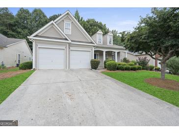 Charming home featuring a two-car garage, manicured lawn, and inviting curb appeal at 377 Avian Forest Dr, Stockbridge, GA 30281