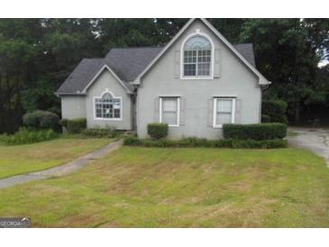 Charming home with a manicured lawn and traditional architectural details at 3336 Harvester Woods Rd, Decatur, GA 30034