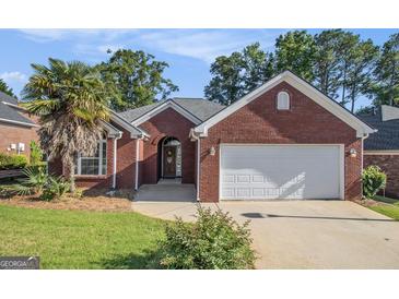 Charming brick home with a well-manicured lawn and an attached two-car garage at 286 Prominent Loop, Mcdonough, GA 30253
