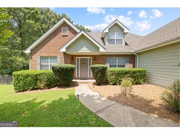 Charming brick home with well-manicured landscaping and a welcoming front entrance with a decorative wreath at 20 Knollwood Pl, Covington, GA 30014