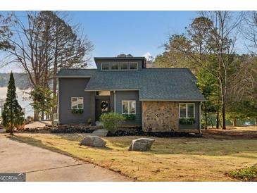 Charming modern home with stone accents and landscaped front yard, perfect for lakeside living at 1190 Plantation Dr, Villa Rica, GA 30180