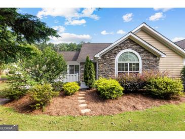Charming home exterior with stone accents, complemented by lush landscaping and a welcoming pathway at 275 Rehobeth Way, Fayetteville, GA 30214