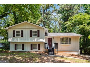 Charming two-story home featuring neutral siding, wood shutters, and a cozy front porch at 234 Kenilworth Cir, Stone Mountain, GA 30083