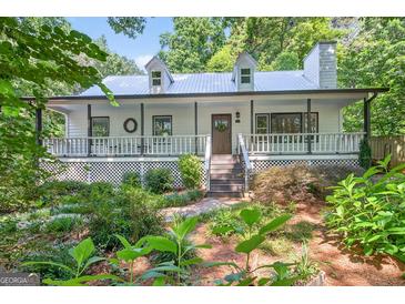 Charming home featuring a welcoming front porch and beautifully landscaped front yard at 3515 Chattahoochee Rd, Cumming, GA 30041