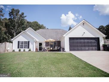 Charming single-Gathering home featuring a well-maintained lawn, inviting front porch and two car garage at 401 N Lost Lake Cv, Villa Rica, GA 30180