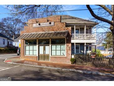 Charming two-story mixed use building featuring a brick front and upper level balcony at 692 Kirkwood Se Ave # A, Atlanta, GA 30316