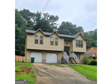 Charming two-story home with a well-maintained lawn and a two car garage at 2071 Scarbrough, Stone Mountain, GA 30088