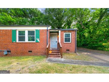Charming brick home featuring well-kept landscaping and a cozy front entrance at 1737 Cahoon Sw St, Atlanta, GA 30310