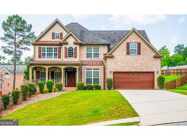 Beautiful two-story brick home with a well-manicured lawn and an attached two-car garage at 4311 Hampton Mill Pkwy, Douglasville, GA 30135