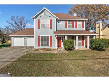 Charming two-story home with red shutters, light blue siding, and a well-manicured lawn at 453 Camp Hill Ln, Jonesboro, GA 30238